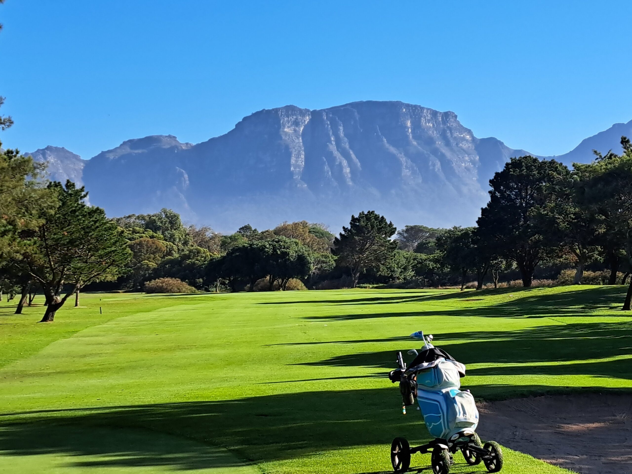 Golf trolley on the fairway with Table Mountain in the background, Western Cape